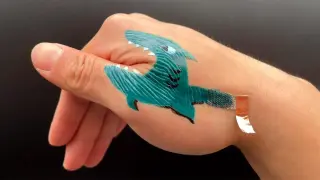 Ink-on-skin tattoo reads ECG and drives a robotic hand