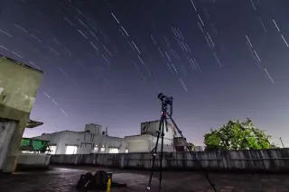 Distant Globular-Cluster Stream Illuminates Dark-Matter Halos Beyond the Milky Way
