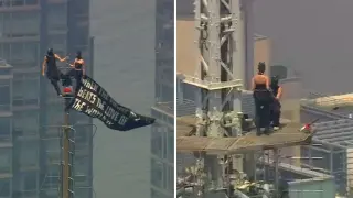 Love on the spire: Daredevil couple's Empire State Building stunt ends with proposal and custody