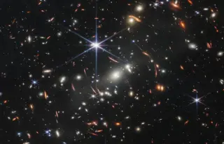 JWST Finds Pristine Galaxy from Cosmic Dawn via Gravitational Lens