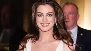 Anne Hathaway radiates maternity glow in bridal-white gown on Odyssey press tour