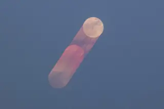 Moon in Motion: Strawberry Moon Glides Over Jaipur's Jal Mahal