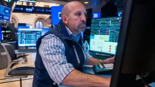 Markets hold near flat as inflation data and earnings loom