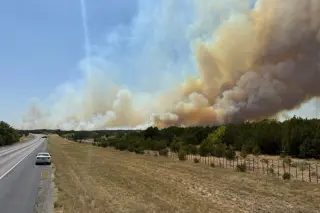 Wildfires push evacuations across Texas and Nevada as flames threaten homes
