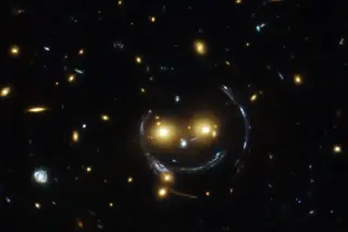 NASA Highlights 2015 Hubble Image of Galaxy Cluster as 'Cosmic Smile' via Gravitational Lensing