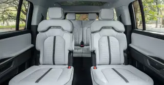 Rivian updates R1S with six-seat captain’s chairs and center-pass-through