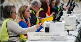 Postal fears drive Democrats to shift from mail to in-person voting