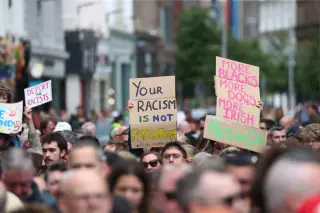Belfast stands against xenophobia after stabbing spurs anti-immigrant rioting