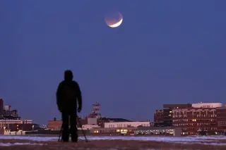 Copper-tinted partial lunar eclipse lights up the Americas Thursday night