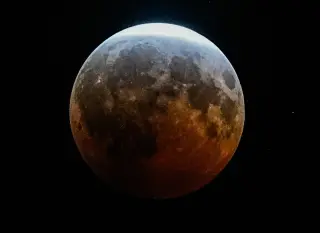 Red glow lights the night as partial lunar eclipse dazzles skywatchers