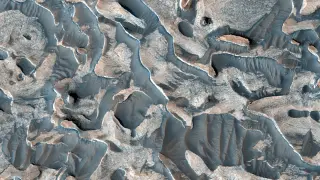 Mars Orbiter Images Reveal Coral-Like Deposits and Violet Polar Cliffs