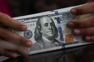 Dollar slips on Treasury buybacks fueling currency jitters ahead of Jackson Hole