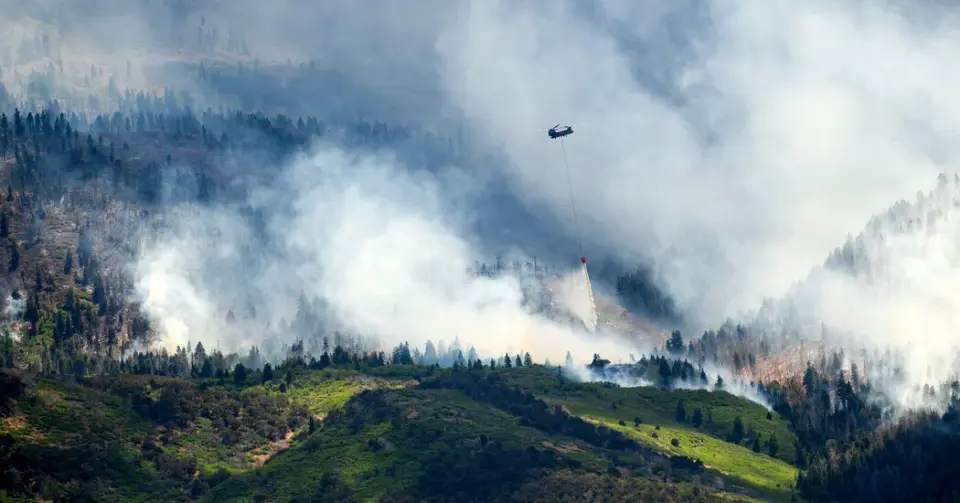 Western wildfires surge as evacuations expand and firefighters die