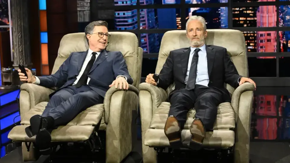 Jon Stewart Honors Colbert’s Final Week With Luxury Recliners and Andra Day Performance