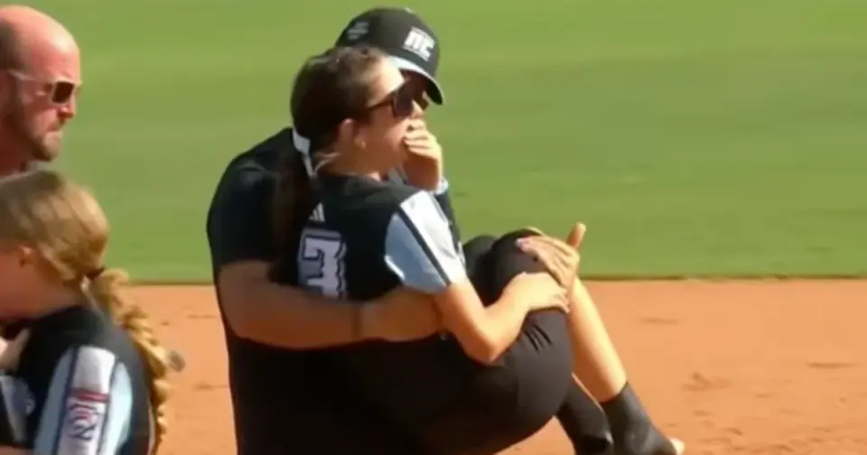 Dad’s on-field carry after daughter’s injury goes viral at softball world series
