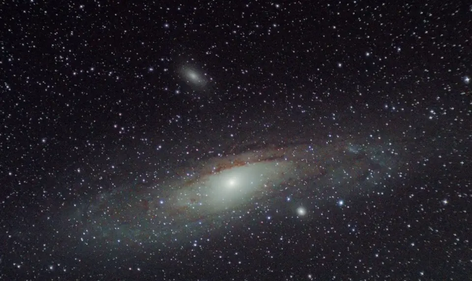 Why Andromeda's Glow Hides Its Planets: The Physics of Extragalactic Detection