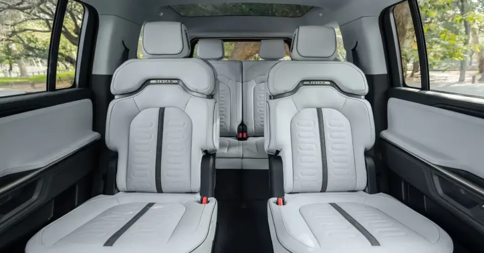 Rivian updates R1S with six-seat captain’s chairs and center-pass-through