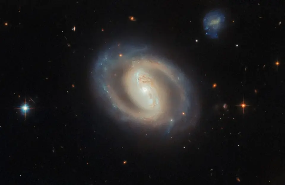 Hubble captures a glowing barred spiral galaxy with a blazing nucleus